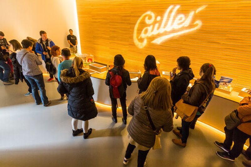 People trying chocolate at the Cailler factory tour in Broc, Switzerland.