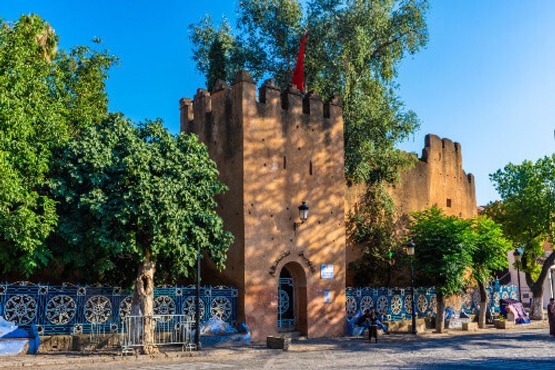 People near the Kasbah or fortress of Chefchaouen.