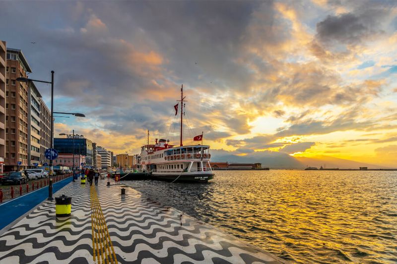 The Kordon with a large cruise ship on the sea during sunset in Izmir