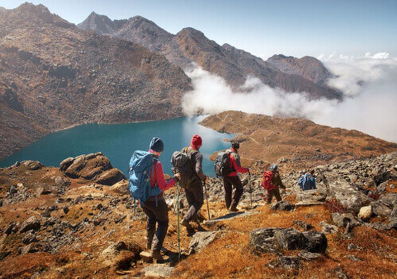Visitors hike alongside the Glacial Lake in Nepal.