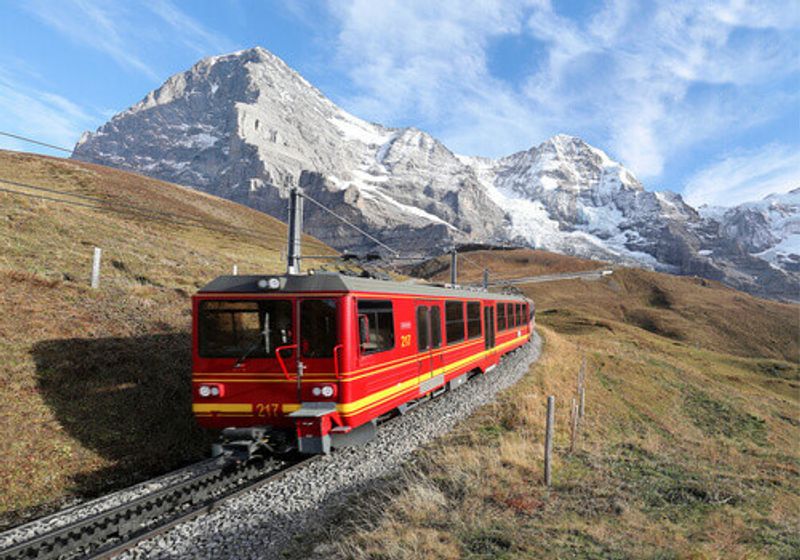 A cog wheel train travels on Jungfrau Railway from Jungfraujoch to Kleine Scheidegg in Bernese Oberland, Switzerland.