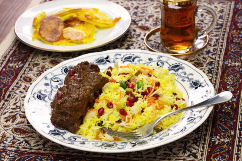 A delicious Iranian fesenjan with rice.