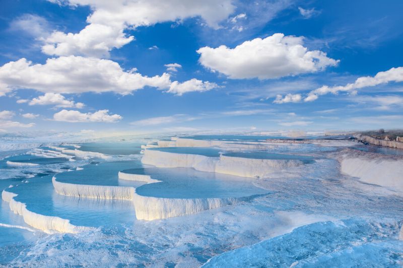 The clear, reflective blue Pamukkale Pools invite tourists and locals year round.