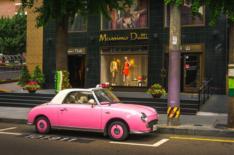 A quaint pink vintage car on the street of Garosugil in Seoul, South Korea.