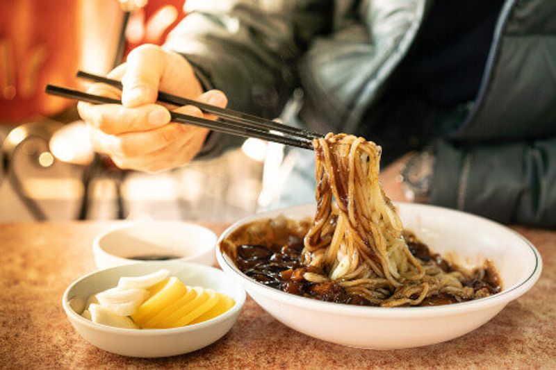 Jajangmyeon or Jjajangmyeon is a Korean noodle topped with a thick sauce made of chunjang or diced pork and vegetables.