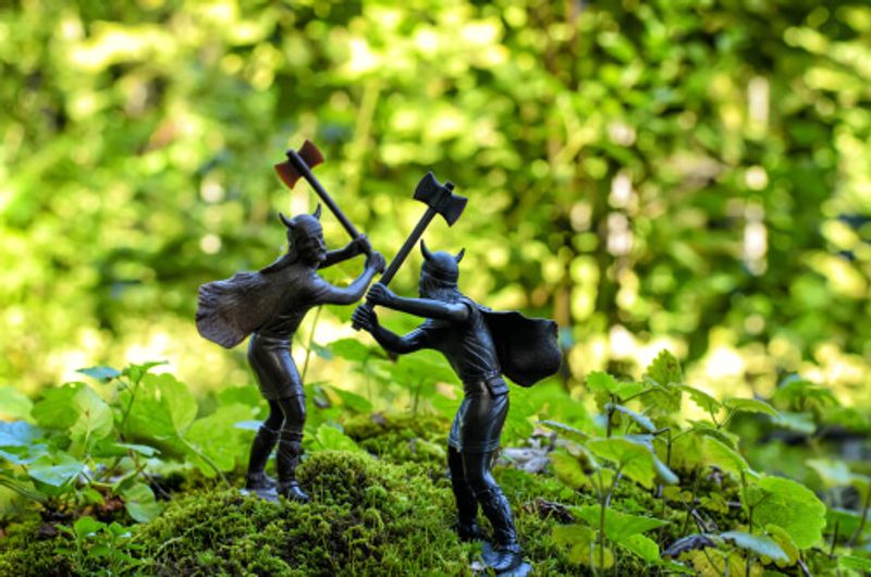 Wooden figures depicting a double axe Viking battle.