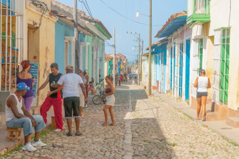 People conversing on the streets of Trinidad, Cuba.