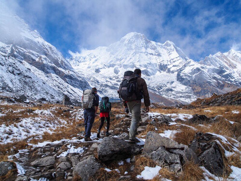 Trekkers walking to the Annapurna Sanctuary Trek in the Himalayas.