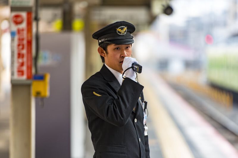Japanese train conductor on a platform
