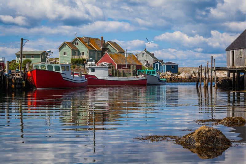 Summer view of fishermen's houses, boats and the harbour at Peggys Cove