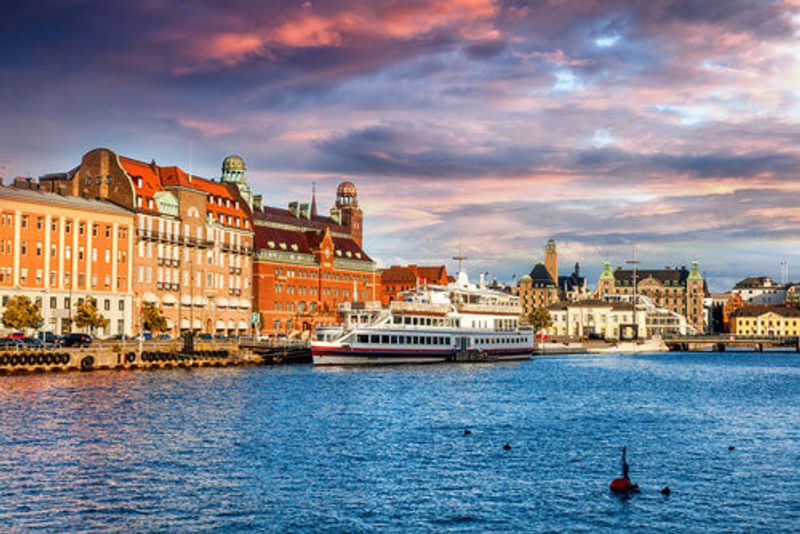 Malmo Harbour is bustling at sunset.