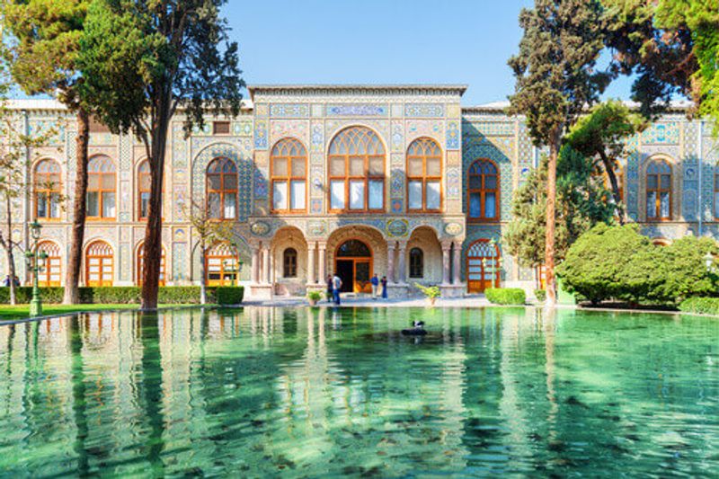 Beautiful view of the Golestan Palace and scenic pond with emerald water in Tehran.