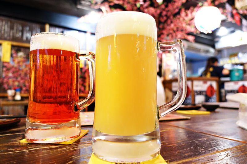 Two glasses of mug beer on a table at an Izakaya restaurant in Tokyo
