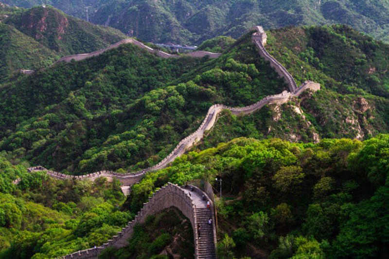 A view of the Great Wall of China, carved into the mountains.