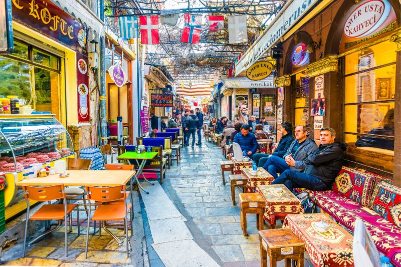 The historical Kemeralti Street view in Izmir with locals sitting at a cafe