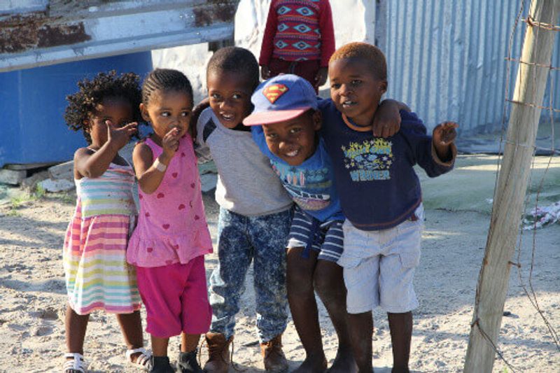 A group of children playing on the road of the township of Khayelitsha.