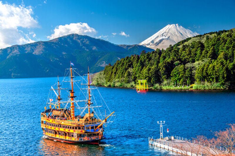 A landscape showing Mount Fuji in background of Lake Ashi and the pirate ship Hakone in Japan.