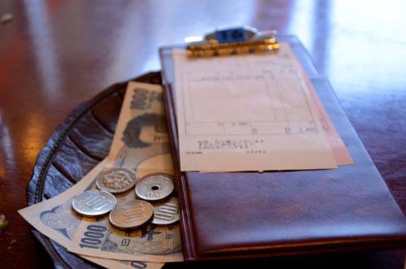 Money left on a tray as a tip in Japan.