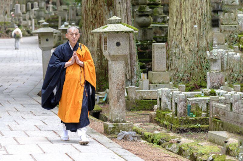 A Shingon Monk walking in Okunoin cemetery, Koyasan, Japan.