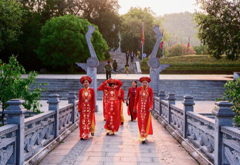 Women in traditional clothing, on a bridge on Phu Tho, Vietnam.