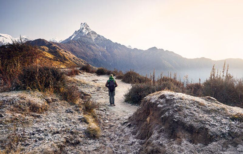 Tourist enjoying the view of snowy Himalayan Mountain of Machapuchare in the Himalayas.