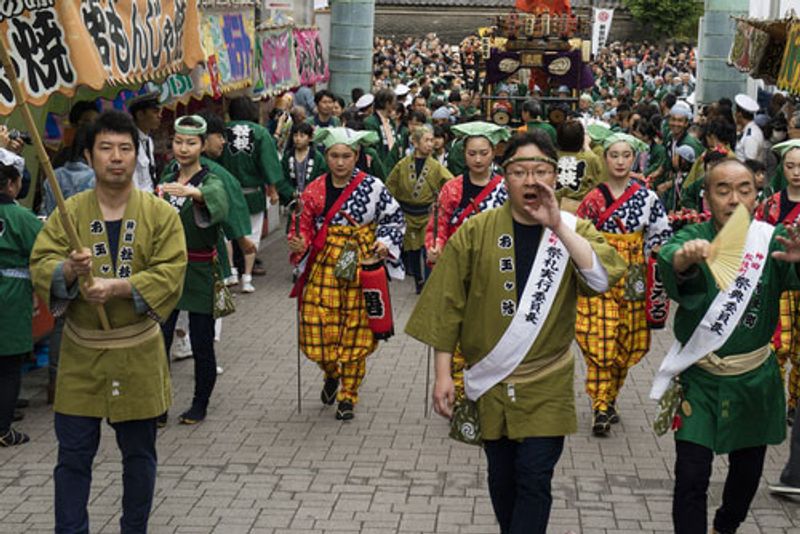 Japanese people in costume walking the streets of Tokyo.