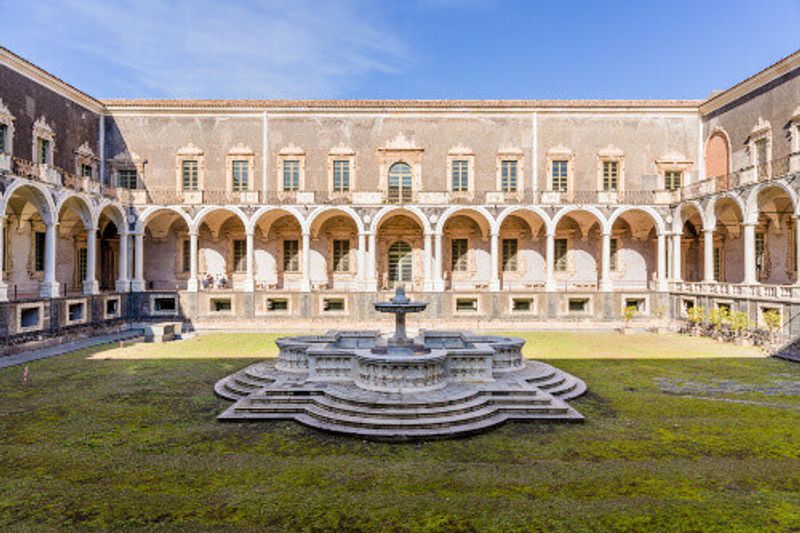 Baroque central courtyard with colonnade in the Benedictine cloister now part of Università dei Benedettini in Catania.