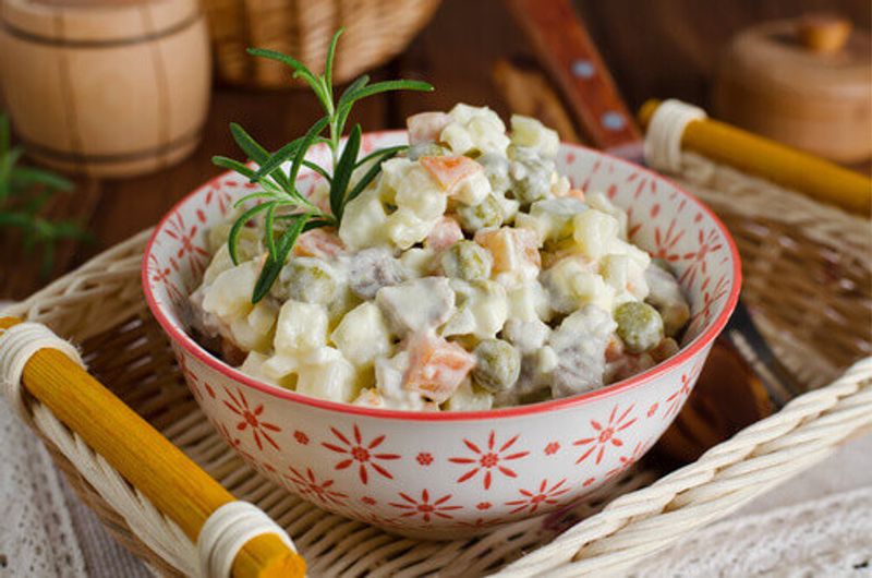 The traditional Russian salad, Olivier, contains vegetables and meat.