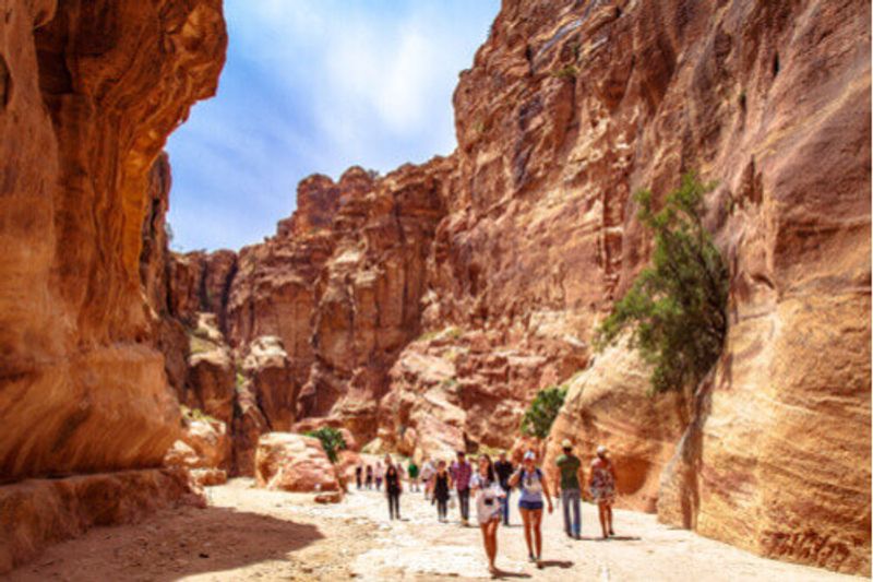 Tourists pass through the ancient site of Petra, Jordan.