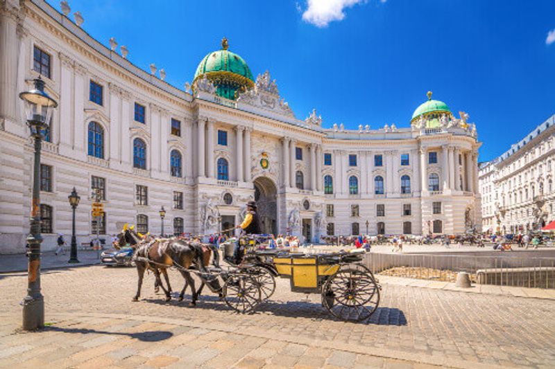 The Hofburg Palace Complex with horse drawn carriages in Vienna.