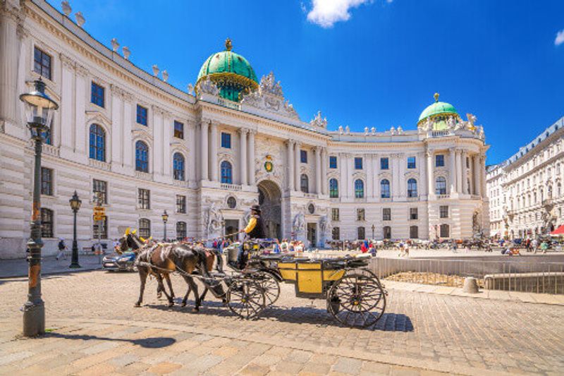 The Hofburg Palace Complex with horse drawn carriages in Vienna.