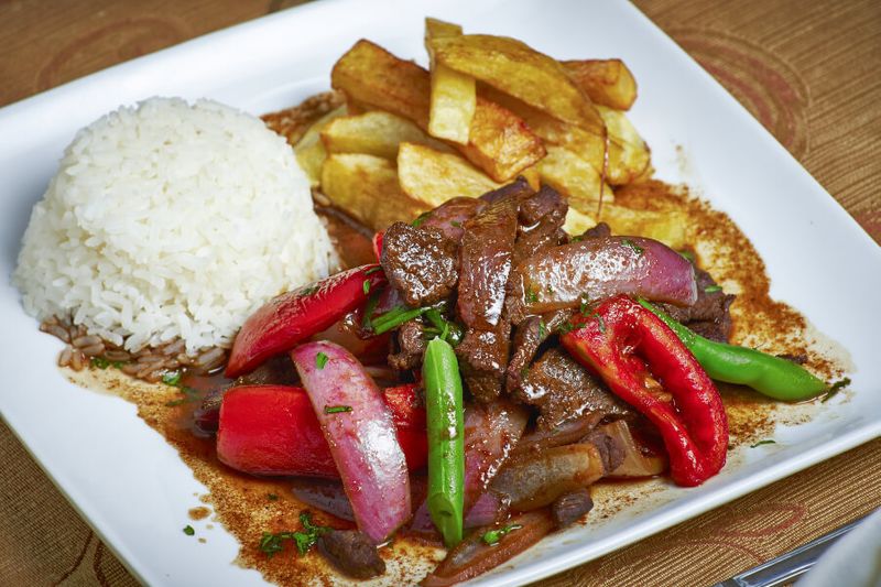 A Peruvian dish called Lomo Saltado served with rice.