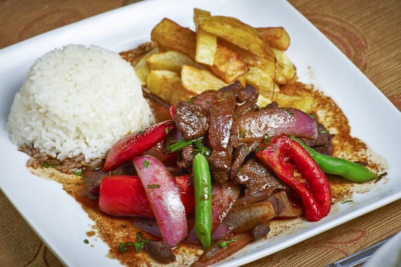 A Peruvian dish called Lomo Saltado served with rice.