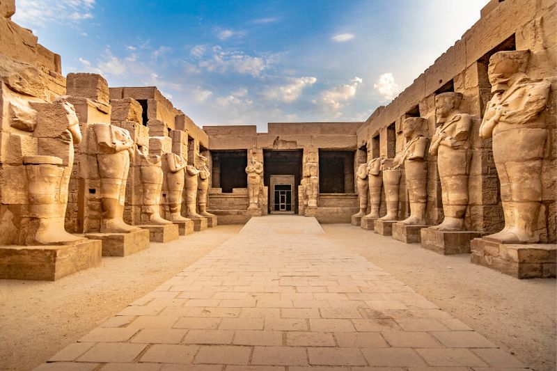 Large sculptures of pharaohs with hieroglyphic symbols in Karnak Temple
