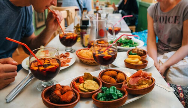 A man enjoys a meal of Tapas and Sangria in Madrid, Spain.