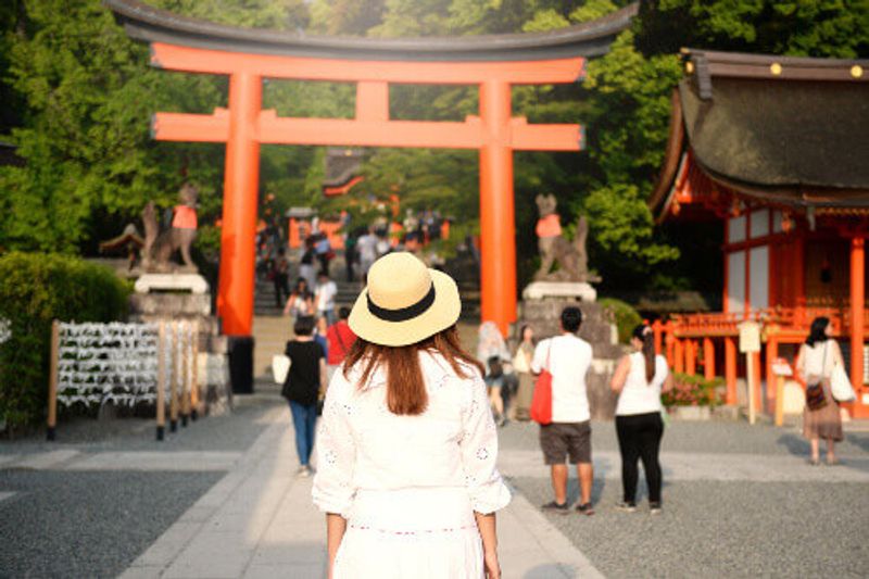 A tourist visits the Fushimi Inari Gate in Kyoto, Japan.