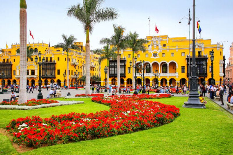 The Plaza Mayor surrounded by the Government Palace, a Cathedral, and Municipal Palaces and more.