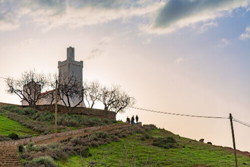 Bouzaafar or The Spanish Mosque on a hill with the sky overlooking Chefchaouen.