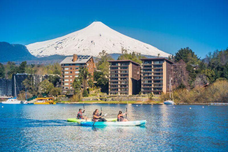 Group of tourists paddling on a kayak in Lake Villarrica, Pucon, Chile.