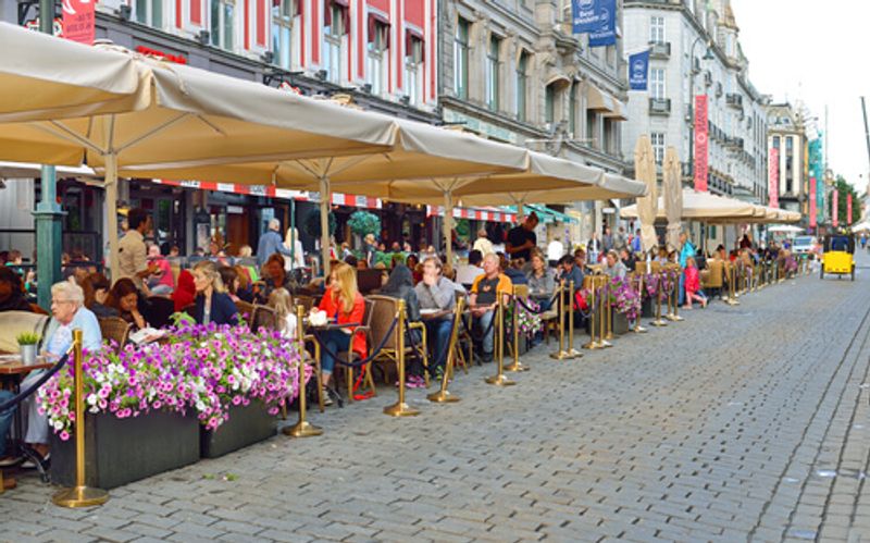 A busy street-side cafe in Oslo.