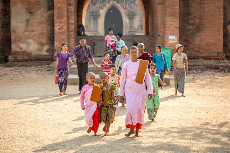 Group of locals walks through one of the thousands of temples in Bangan.