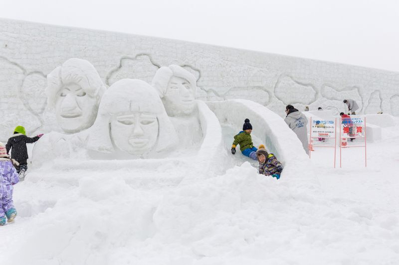 Children play near the Tsudome Snow Sculpture.