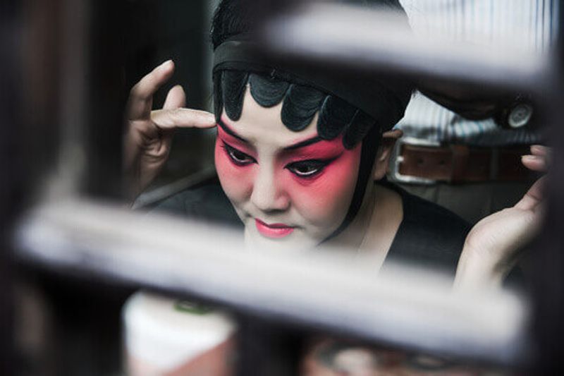 Close-up of a chinese opera actress doing make up in Suzhou, China.