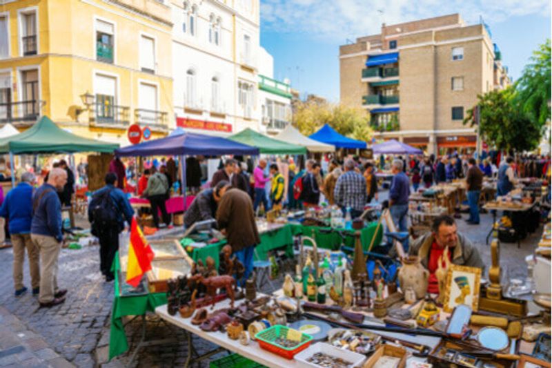 Under tents, locals sell thier wares at the Seville Flea Market.