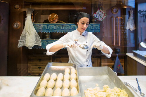 A local female chef is making cod fritters in Portugal.