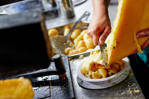 Cheese raclette with potatoes at a market